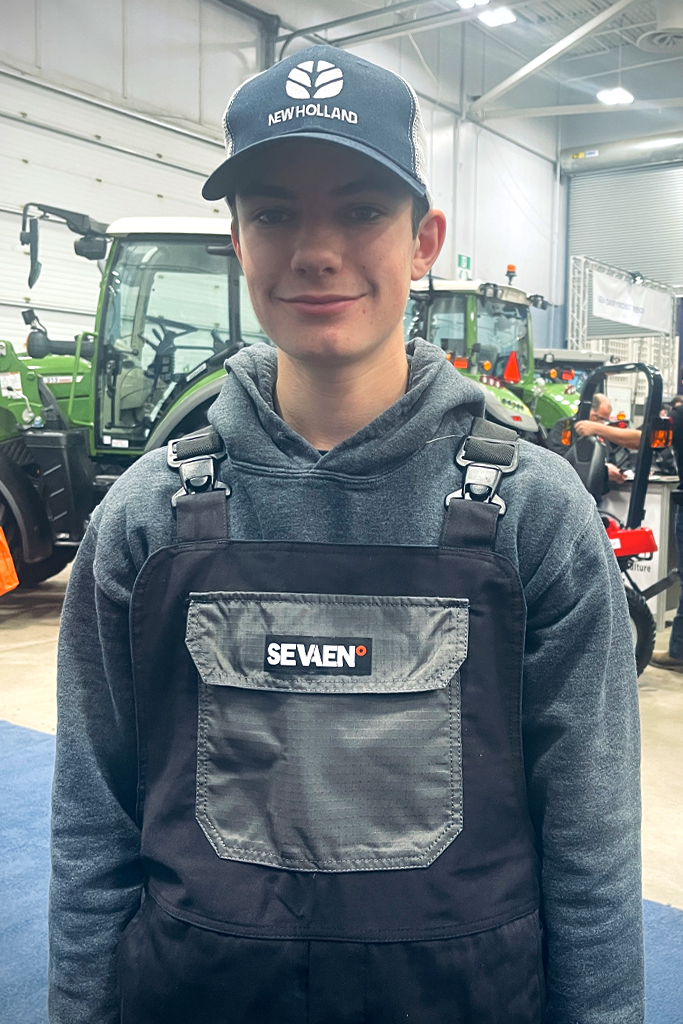 A young farmer wearing the AG wear by Sevaen overalls at the ATlantic Farm Mechanization show 2022, Moncton, NB